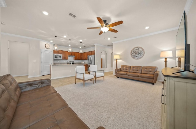 carpeted living room featuring crown molding and ceiling fan