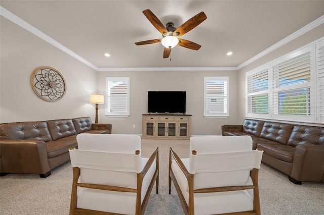 living room with ornamental molding, light colored carpet, and ceiling fan