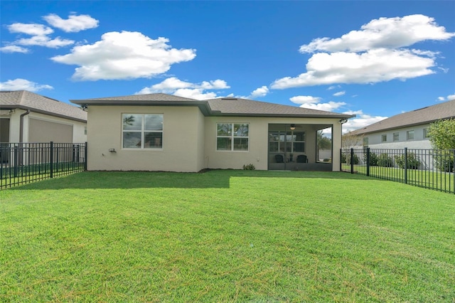 back of property featuring a lawn