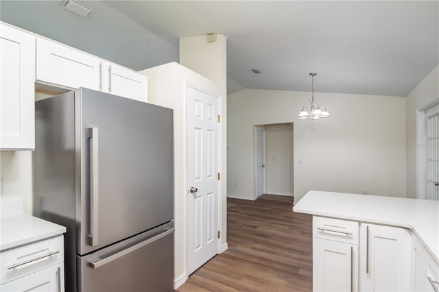 kitchen with white cabinetry, lofted ceiling, stainless steel fridge, and light wood-type flooring