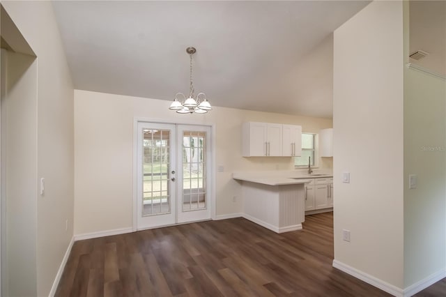 kitchen featuring white cabinetry, french doors, dark hardwood / wood-style floors, and hanging light fixtures