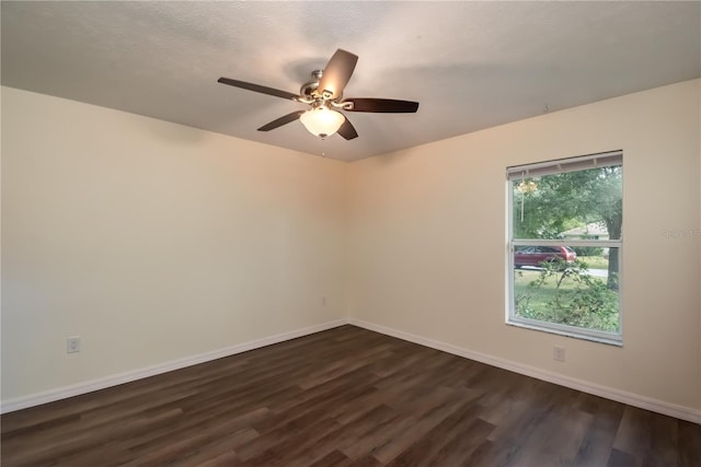 spare room with dark wood-type flooring, a textured ceiling, and ceiling fan