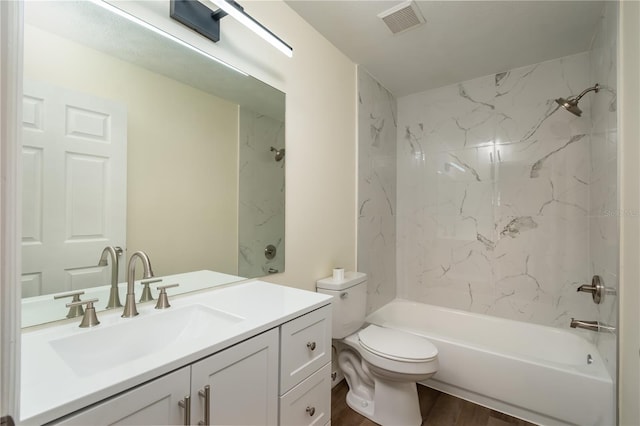 full bathroom featuring toilet, tiled shower / bath, vanity, and wood-type flooring