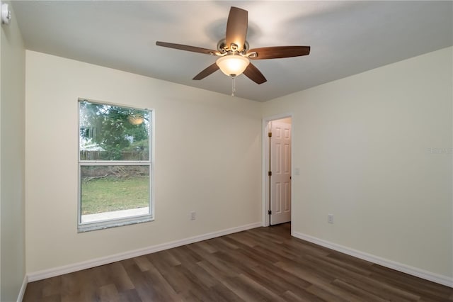 spare room featuring dark wood-type flooring and ceiling fan