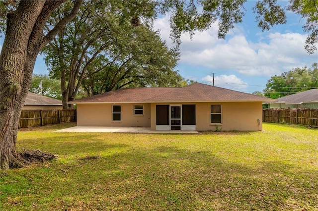 rear view of property featuring a patio area and a yard