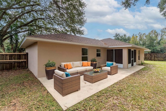 rear view of house featuring a patio, outdoor lounge area, a yard, and a sunroom