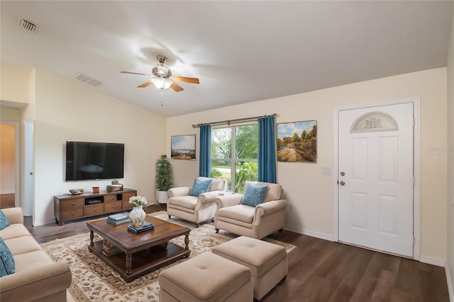 living room with lofted ceiling, dark wood-type flooring, and ceiling fan