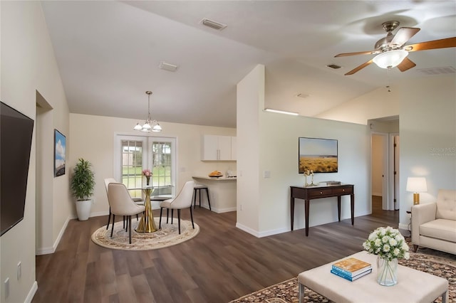 living room with dark wood-type flooring, lofted ceiling, and ceiling fan with notable chandelier