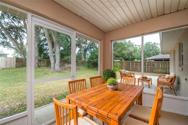 sunroom / solarium featuring lofted ceiling