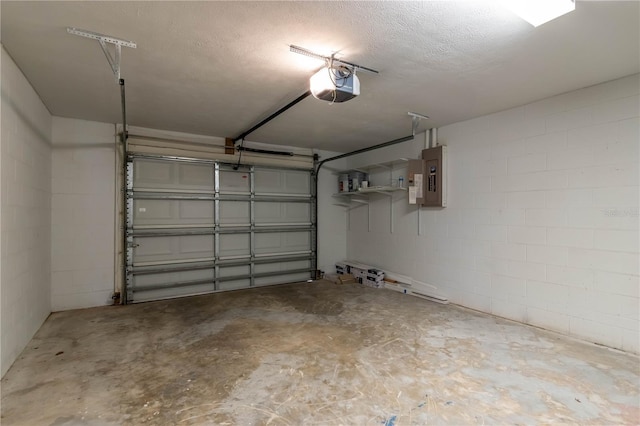 garage with a garage door opener and electric panel