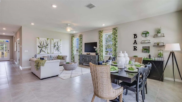 dining space featuring light tile patterned floors, a healthy amount of sunlight, and ceiling fan