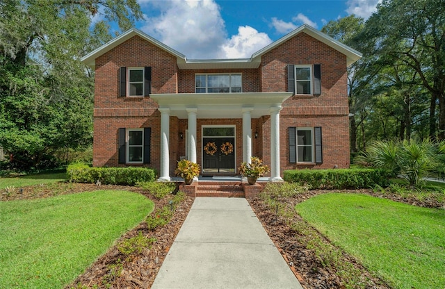 view of front of property with a porch and a front yard