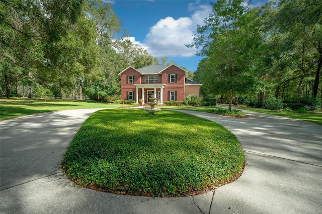 colonial inspired home with a front yard