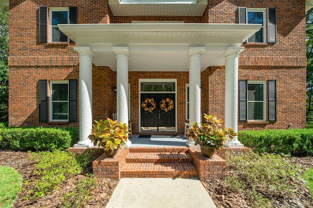 view of exterior entry with a porch