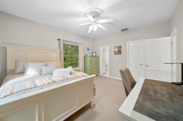 carpeted bedroom with connected bathroom and ceiling fan