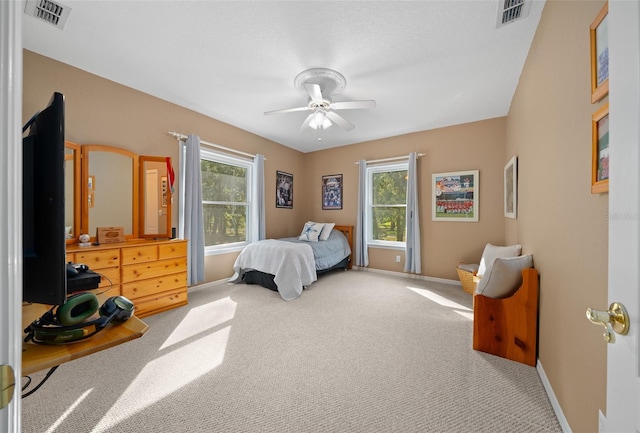 bedroom featuring multiple windows, carpet floors, and ceiling fan