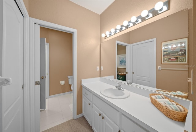 bathroom featuring vanity, toilet, and tile patterned floors