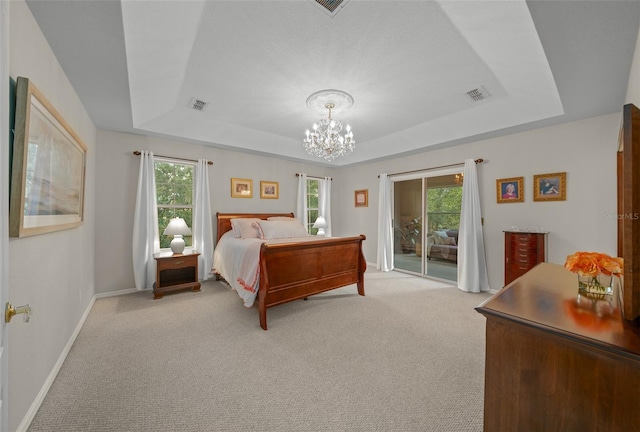 bedroom featuring light carpet, a notable chandelier, access to exterior, and a raised ceiling