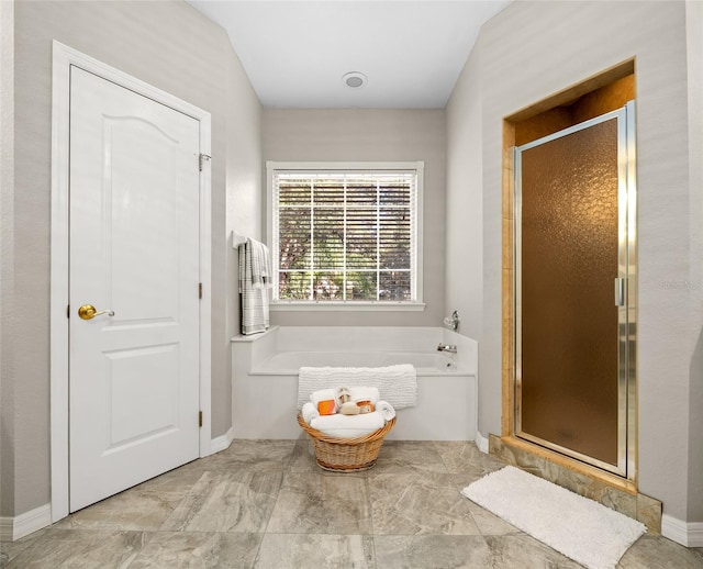 bathroom featuring separate shower and tub and vaulted ceiling