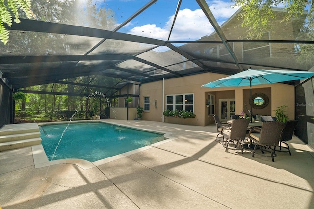 view of pool featuring pool water feature, a patio area, and glass enclosure