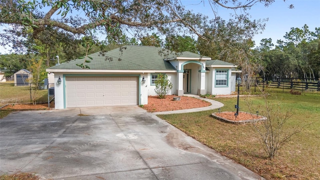 single story home featuring a front lawn and a garage