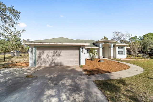 view of front of home featuring a front yard and a garage