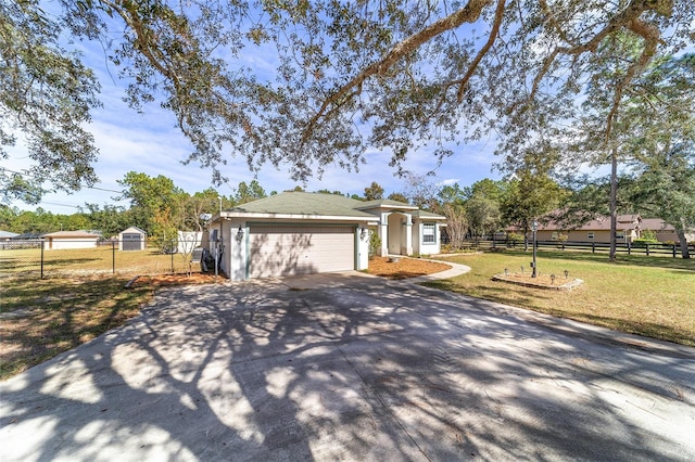 view of front of home featuring a front yard and a garage