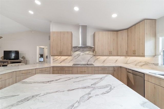 kitchen with light brown cabinetry, wall chimney range hood, black electric cooktop, vaulted ceiling, and stainless steel dishwasher