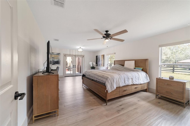 bedroom with french doors, ceiling fan, and light hardwood / wood-style floors