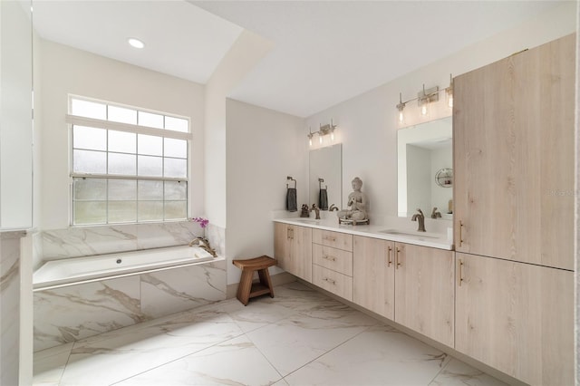 bathroom with vanity and a relaxing tiled tub