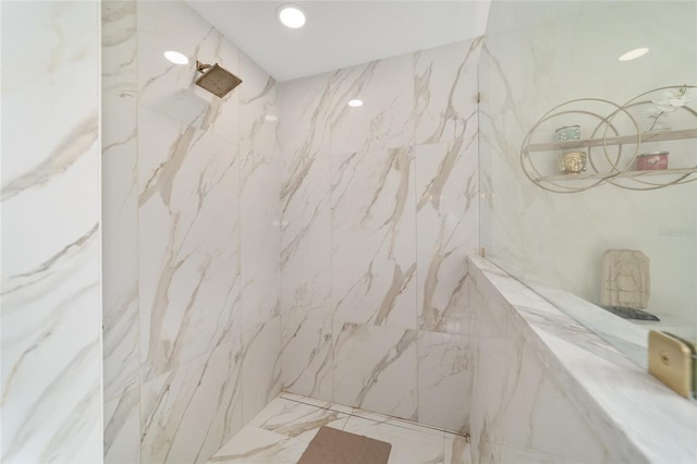 bathroom featuring tile walls and a tile shower