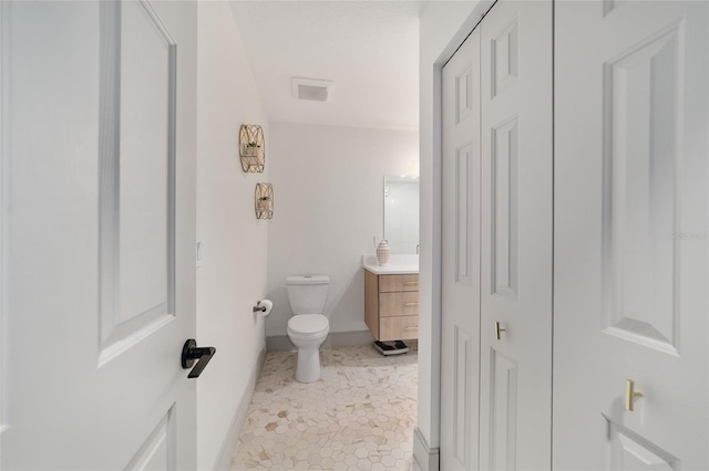 bathroom featuring vanity, toilet, and tile patterned flooring