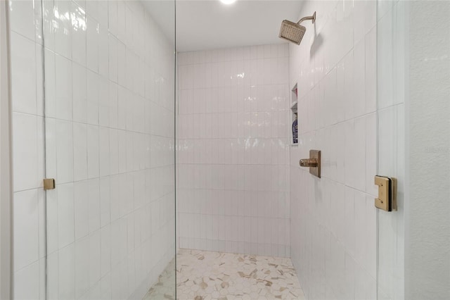 bathroom with tiled shower