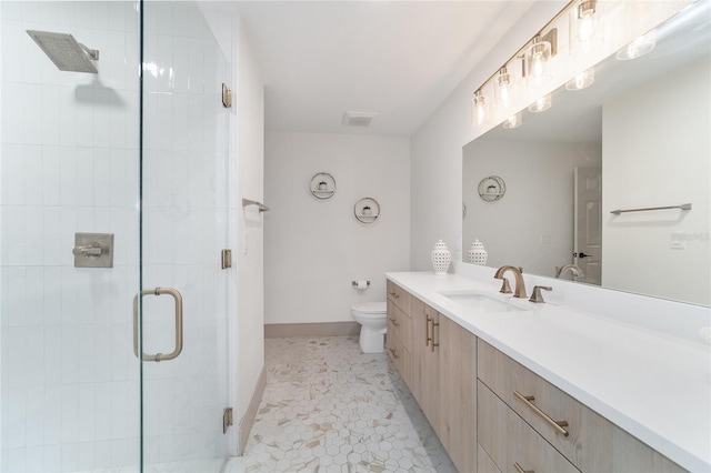 bathroom featuring vanity, walk in shower, toilet, and tile patterned flooring