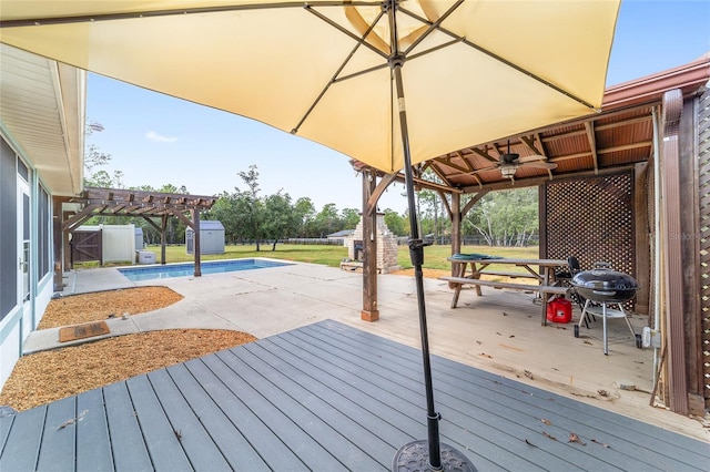 wooden deck with a pergola, ceiling fan, and a grill