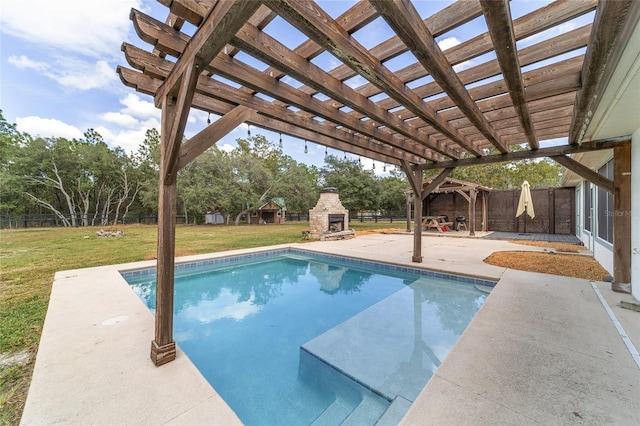 view of pool with a patio, a pergola, an outdoor stone fireplace, and a yard