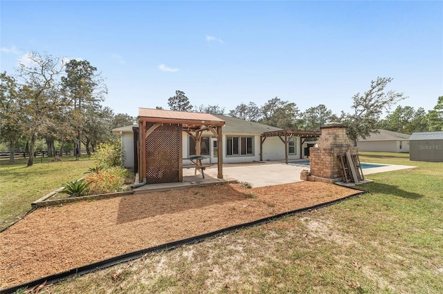 back of house with a patio and a yard