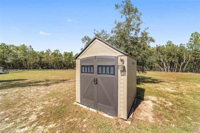 view of outbuilding featuring a yard