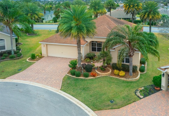 view of front of house featuring a front yard and a garage