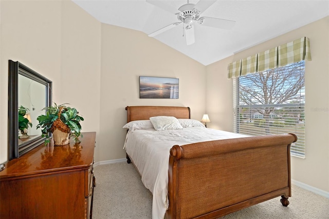 bedroom featuring vaulted ceiling, light colored carpet, and ceiling fan