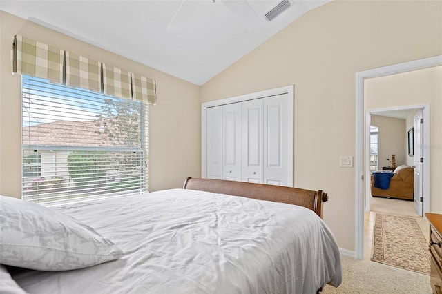 bedroom featuring a closet, ceiling fan, carpet flooring, and lofted ceiling