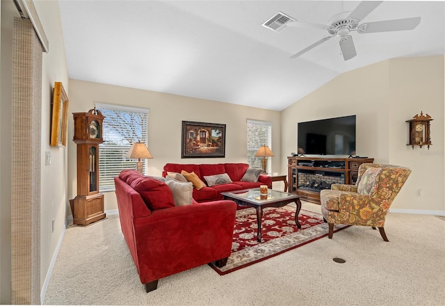 carpeted living room featuring ceiling fan and lofted ceiling