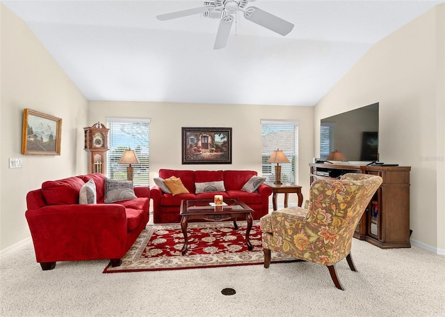 carpeted living room with ceiling fan and vaulted ceiling