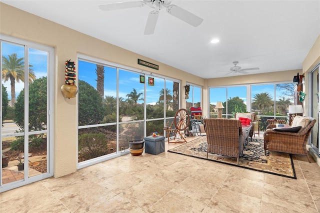 sunroom / solarium featuring ceiling fan and a wealth of natural light