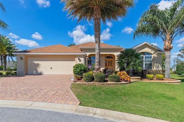 view of front facade featuring a garage and a front lawn