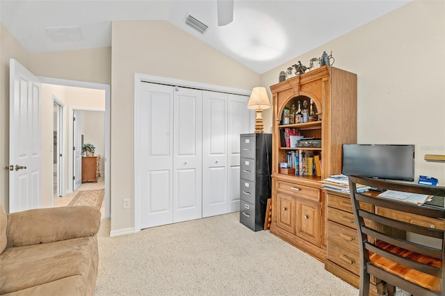 office space featuring vaulted ceiling, light colored carpet, and ceiling fan