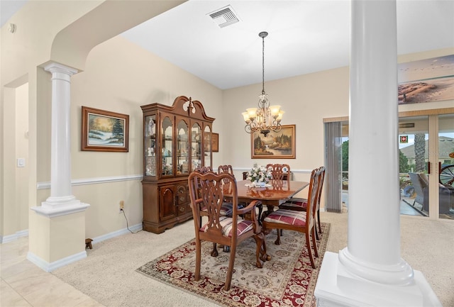 dining room featuring a notable chandelier and ornate columns