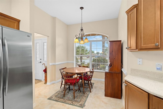 dining room featuring light tile patterned flooring and a chandelier