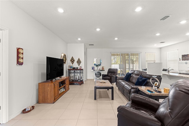 living room with light tile patterned floors and a textured ceiling