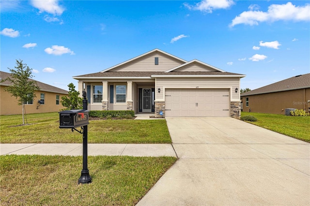 view of front of home with a front lawn, central AC unit, and a garage